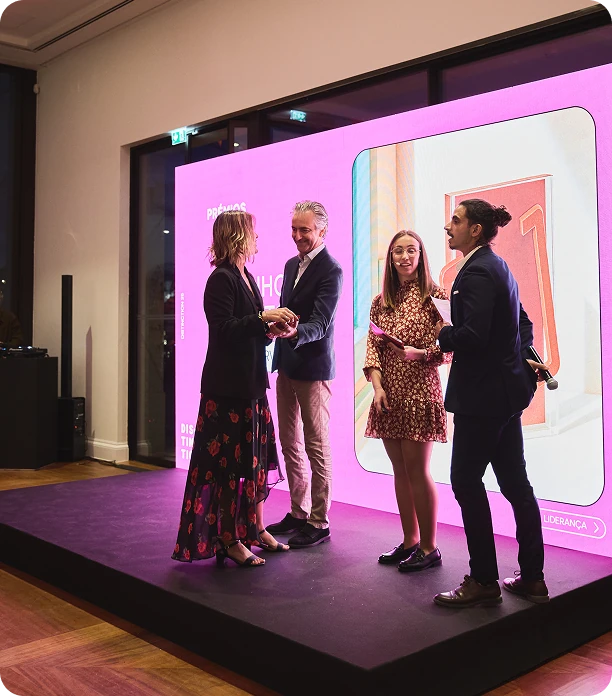 Four people on stage at an awards event